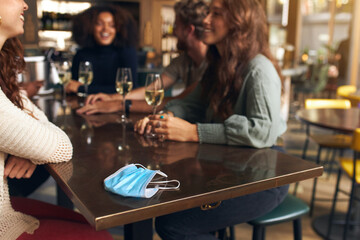 Friends relaxing in bar with drinks