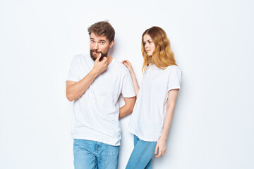 fashionable young couple in white t-shirts and jeans mockup design