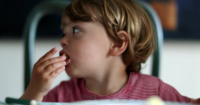 Toddler child grabbing food from table. kid eating