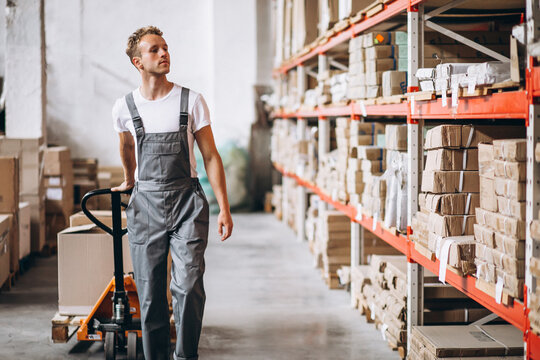 Young man working at a warehouse with boxes