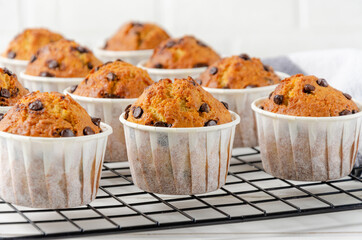 Ready muffins with chocolate chips on a white wooden background. Recipe step by step. Top view.
