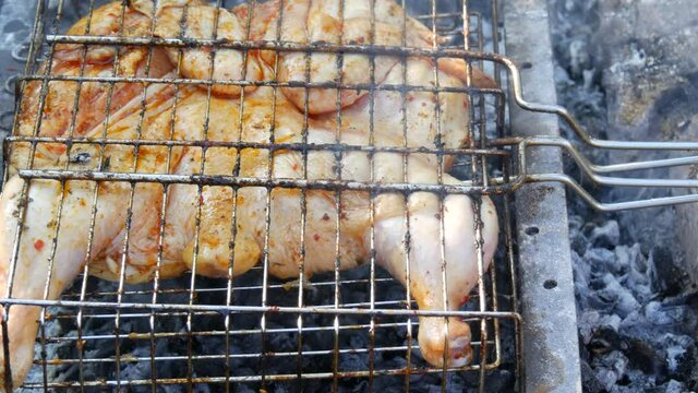 Whole juicy with spices grilled chicken tabaka or tapaka at summer picnic