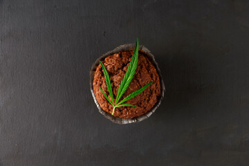 Chocolate muffin or cake with cannabis leaf, cbd infused