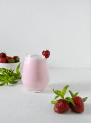 Homemade strawberry milkshake on white background.  Consept of healthy food and home coocking. Copy space.