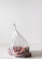 plastic bag with strawberries on white background. Concept of Recycling plastic and ecology. zero waste. Copy space