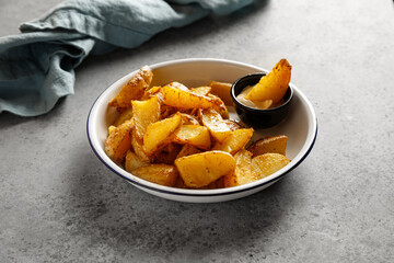 Baked potatoes on plate on grey table with napkin