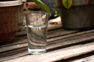 holding a glass cup on a white background