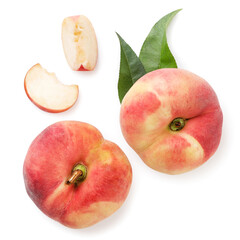 Flat peaches with green leaves whole and slices on a white background, isolated. The view from top