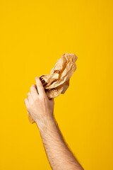 Hands hold recycling paper isolated on yellow background. Stop nature garbage, ecology environment protection concept. Save planet packaging mockup..