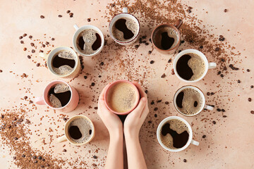 Female hands and cups of coffee on color background