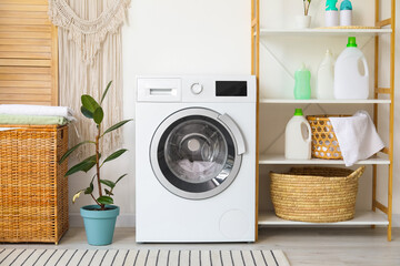 Interior of bathroom with modern washing machine