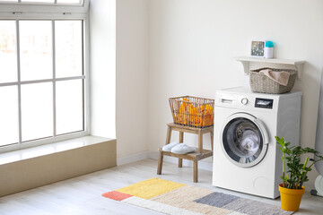 Interior of bathroom with modern washing machine