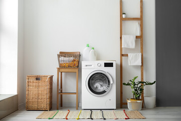Interior of bathroom with modern washing machine