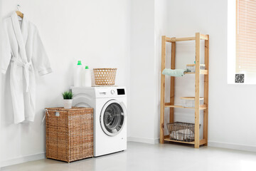 Interior of bathroom with modern washing machine