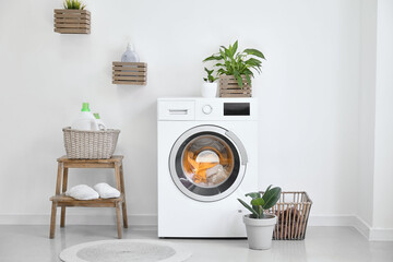 Interior of bathroom with modern washing machine