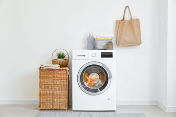 Interior of bathroom with modern washing machine