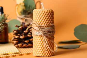 Handmade wax candle on color background