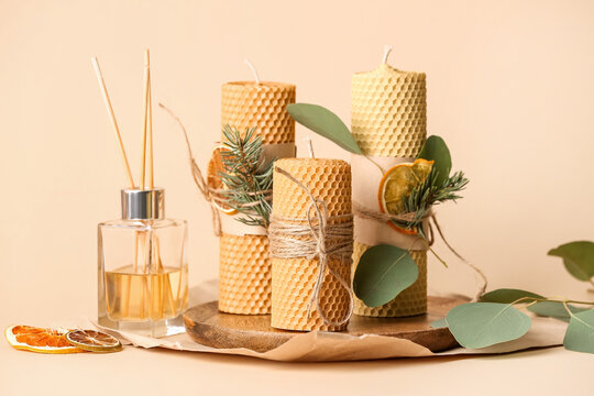 Handmade Wax Candles And Reed Diffuser On Color Background