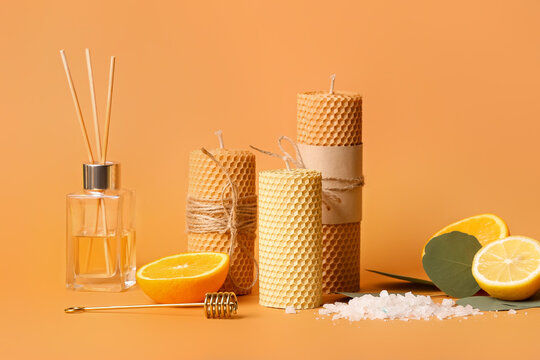 Composition With Handmade Wax Candles, Reed Diffuser And Fruits On Color Background