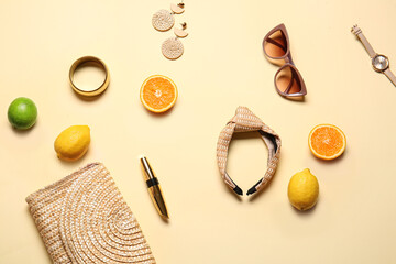 Composition with female accessories and citrus fruits on color background