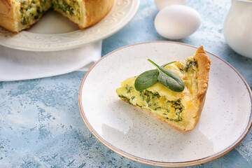 Plate with piece of spinach tart on color background, closeup