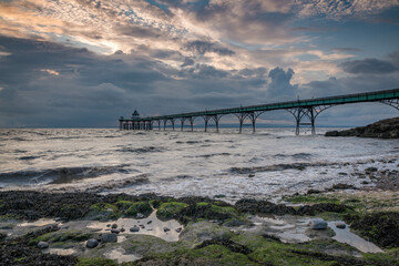 Fototapeta premium beach, blue, Clevedon Pier, clouds, coast, coastal, england, grey, moss, pebbles, pier, pools, puddles, rays, reflection, rocks, sand, sea, seaside, seaweed, sky, Somerset, structure, sun, sun rays, 