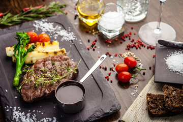 Black Angus New York steak. Marbled beef sirloin from Uruguay. Delicious healthy traditional food closeup served for lunch in modern gourmet cuisine restaurant