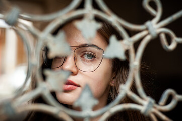 Young woman in clear eyeglasses on the street