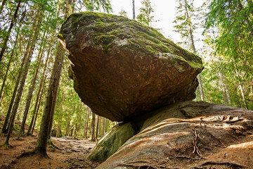 A large balancing boulder rock called Kummakivi in Finnish nature near Ruokolahti - 449193919
