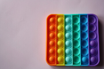 A colorful sensory toy fidget pushes it.