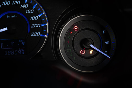 Close up the fuel indicator light on the dashboard of the car To add gasoline