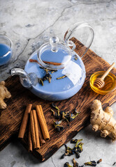 selective focus, freshly brewed blue masala tea in a transparent teapot, with fruits and fresh berries. leaf tea and spices. still-life. for advertising and menus