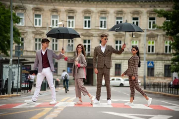 Foto op Plexiglas Stylish young people in classic clothes and glasses communicate with each other outdoor © alipko