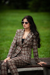 Fashion young woman in formal clothes and sunglasses