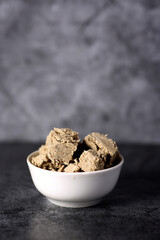 white bowl of halva isolated on gray background