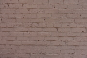 Aged painted pinkish brown brick work with uneven surface