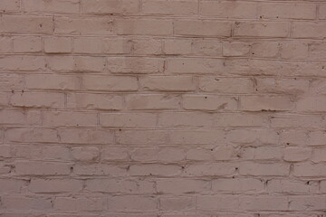 Rough surface of old painted pinkish brown brick work