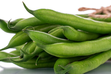 Several ripe green beans, close-up, isolated on white.