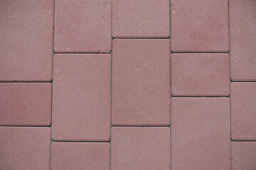 Texture of pavement made of simple pink concrete blocks