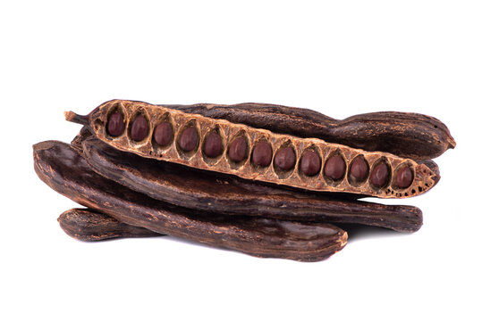 Kerob seeds isolated on white background. Vegerarian cocoa