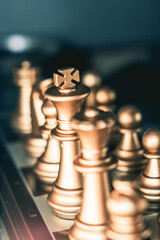 Vertical closeup shot of an arranged chess board with golden pieces