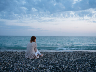woman sitting by the ocean landscape nature rest freedom
