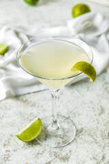 Glass with tasty daiquiri cocktail on light background