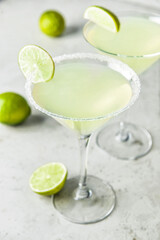 Glasses with tasty daiquiri cocktail on light background