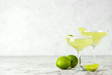 Glasses with tasty daiquiri cocktail on light background