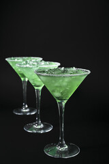 Glasses of cold daiquiri cocktail on dark background