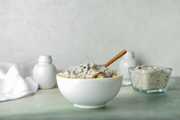 Bowl with tasty mashed potatoes and mushrooms on table