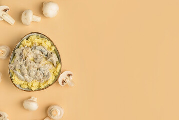 Bowl with tasty mashed potatoes and mushrooms on color background