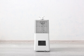 Modern humidifier on floor in room