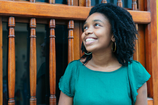 Beautiful and cheerful African American woman in good mood stand
